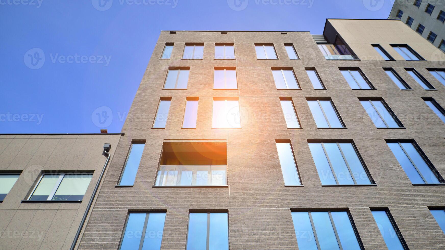 Modern office building detail. Perspective view of geometric angular concrete windows on the facade of a modernist brutalist style building. photo