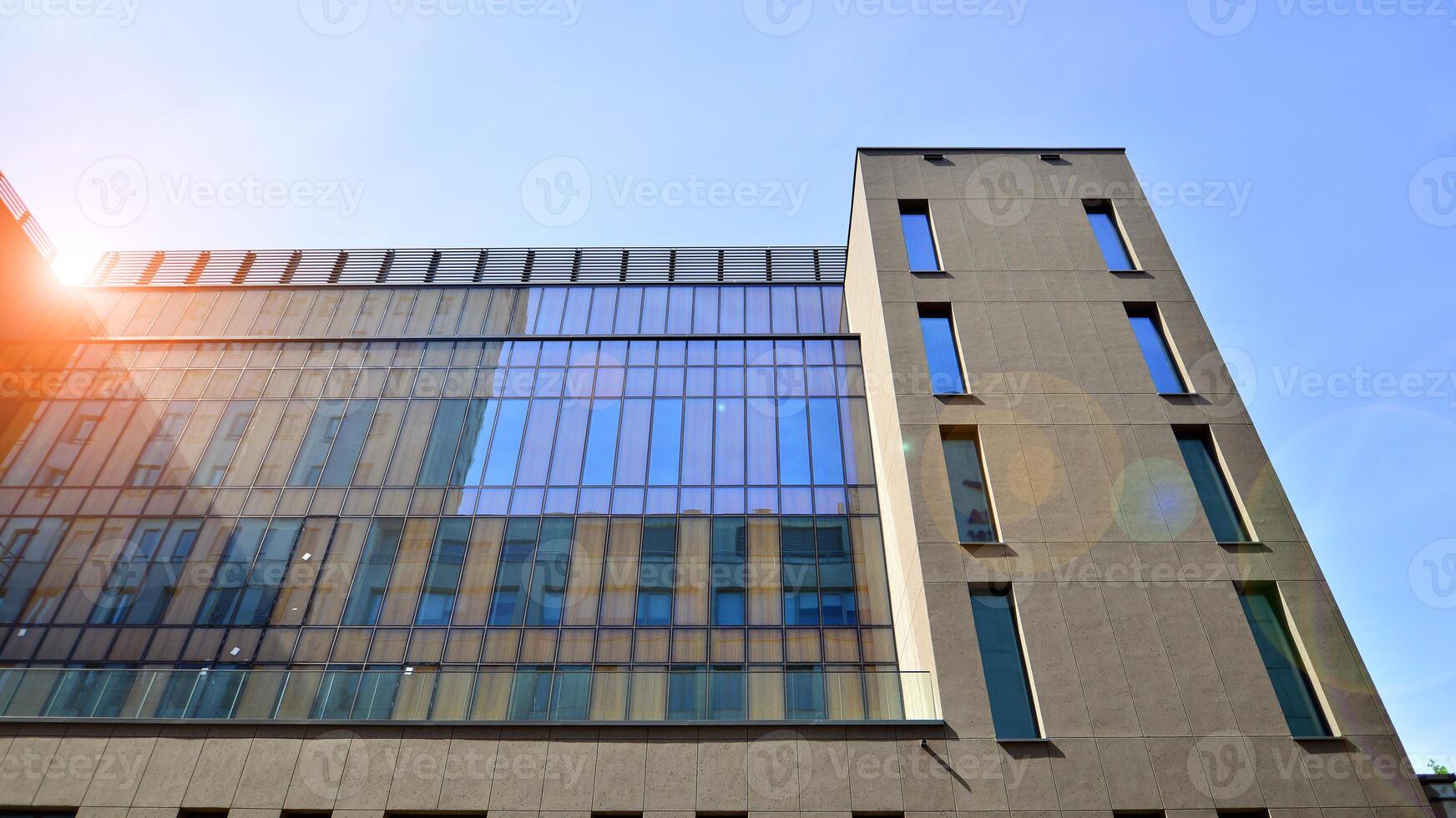 Modern office building detail. Perspective view of geometric angular concrete windows on the facade of a modernist brutalist style building. photo