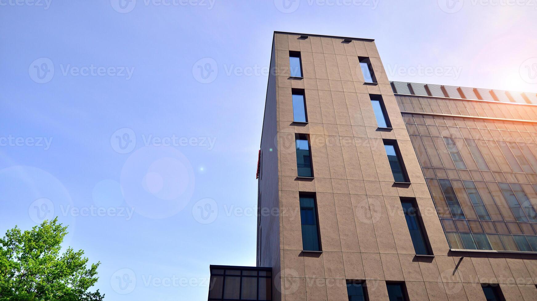 Modern office building detail. Perspective view of geometric angular concrete windows on the facade of a modernist brutalist style building. photo