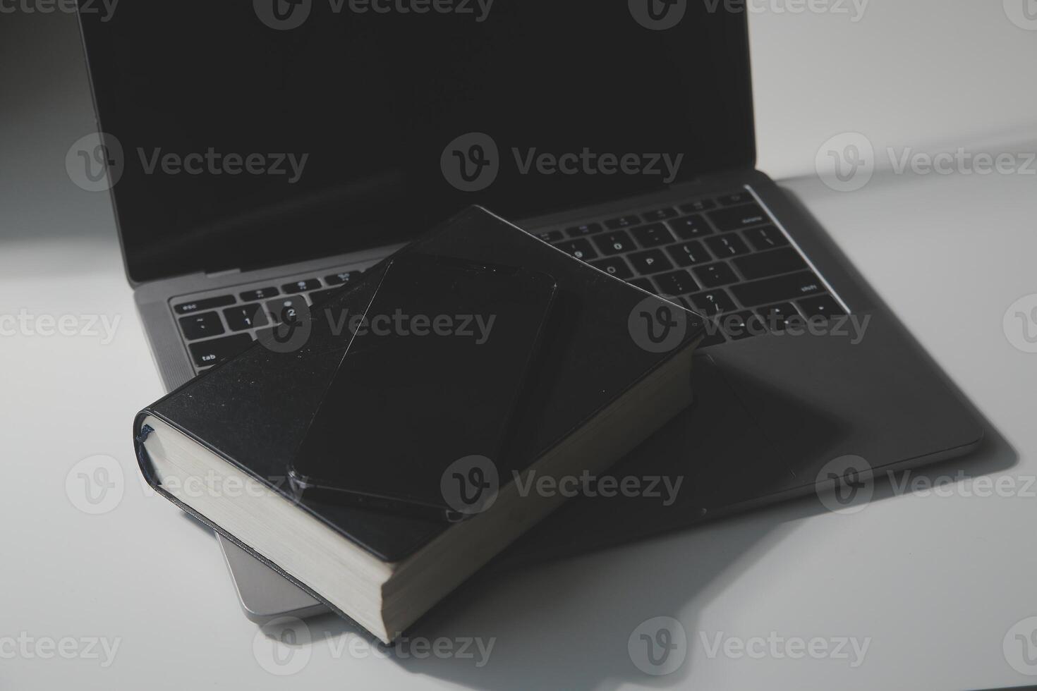 Office workplace with text space, White wooden table with office supplies tablet, desktop computer and book, top view, over light photo