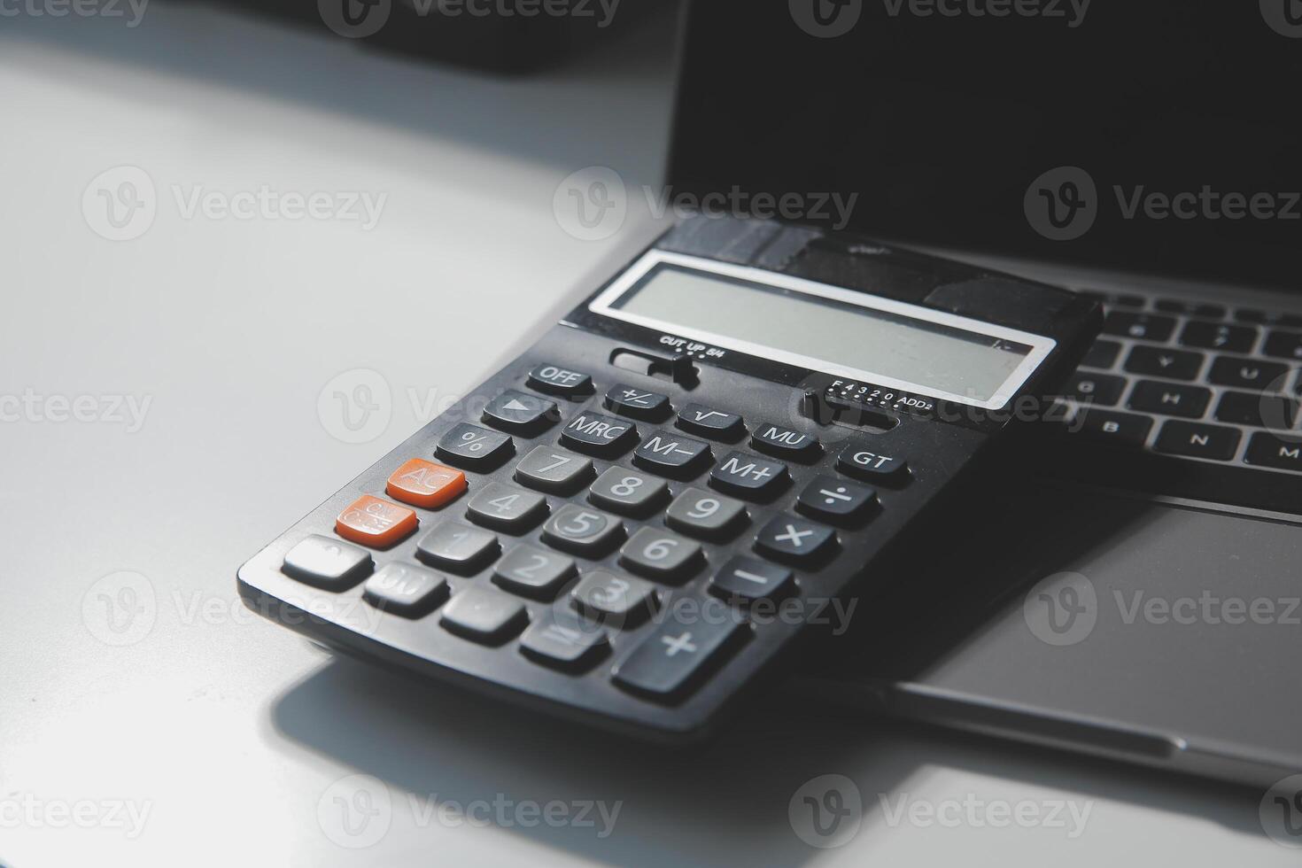 Flat lay, top view office table desk. Workspace with calculator,pen,laptop on white background.Copy Space for text,Empty Blank to word.Business Finance,Education Technology.Work from home. photo