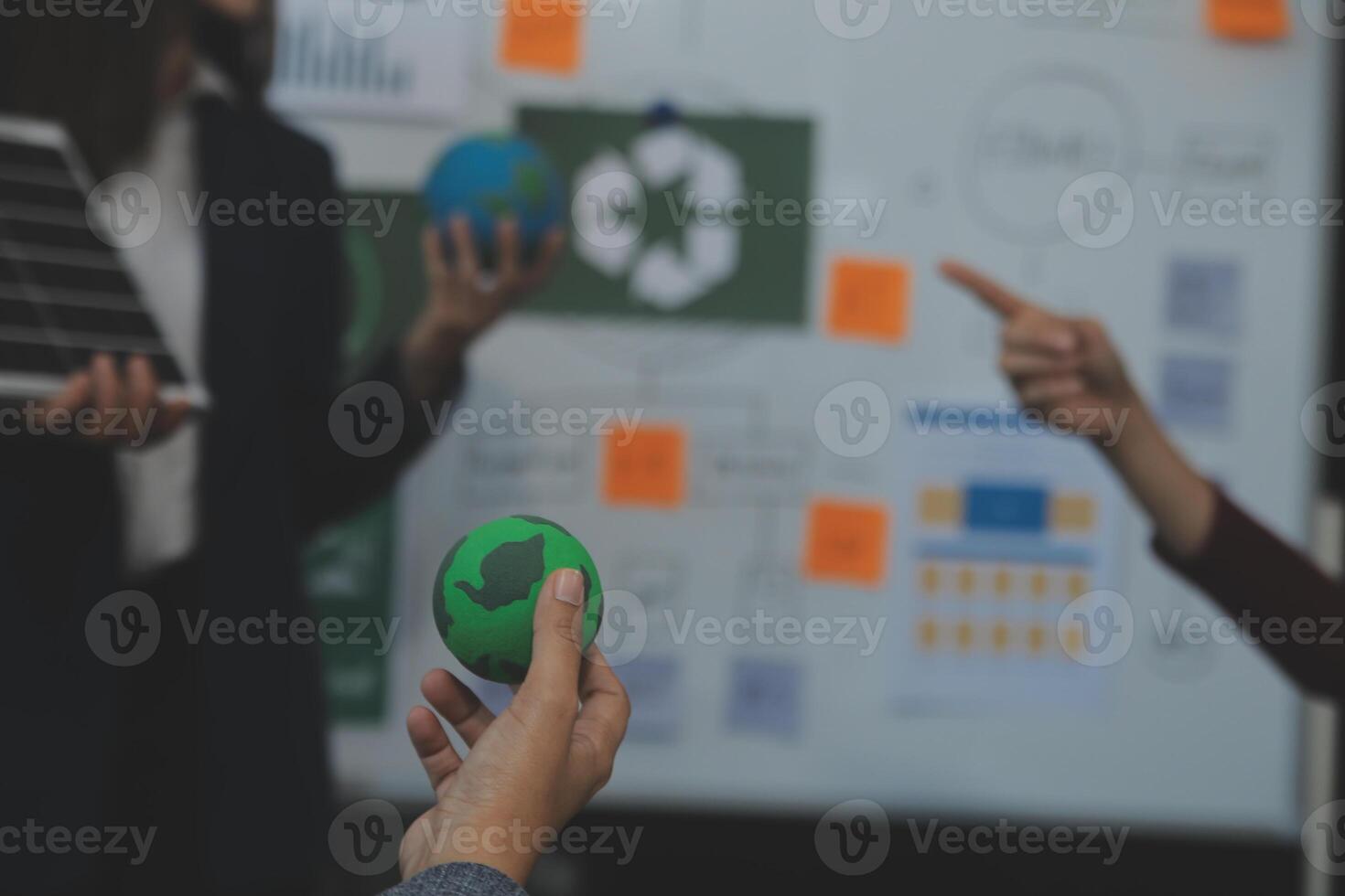 Business people having consultation about wind energy at company office. Business team discussing about windmill and alternative green energy. Executive meeting at modern office photo