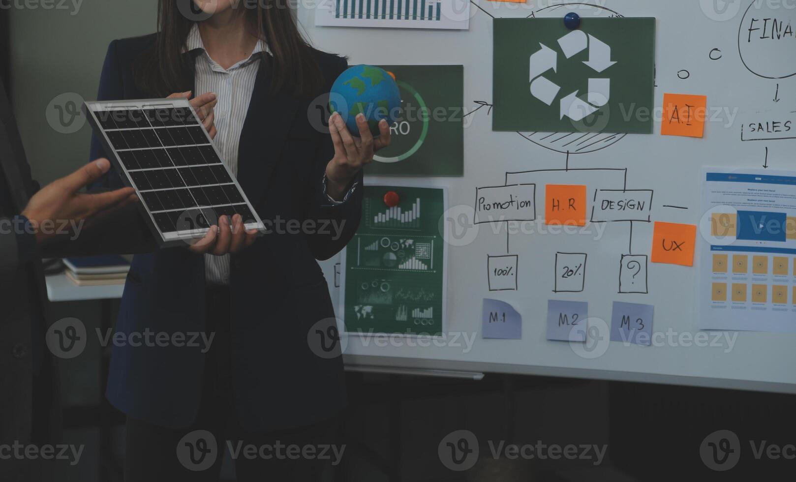 Business people having consultation about wind energy at company office. Business team discussing about windmill and alternative green energy. Executive meeting at modern office photo