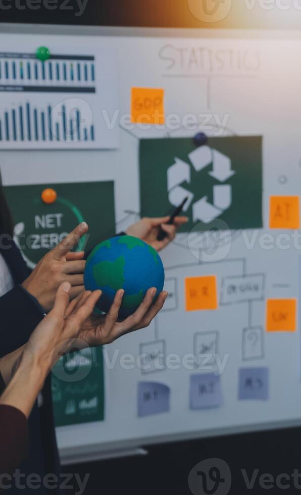 Business people having consultation about wind energy at company office. Business team discussing about windmill and alternative green energy. Executive meeting at modern office photo