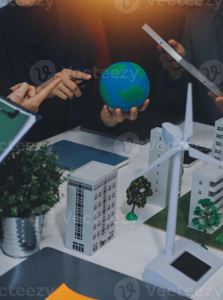 Business people having consultation about wind energy at company office. Business team discussing about windmill and alternative green energy. Executive meeting at modern office photo