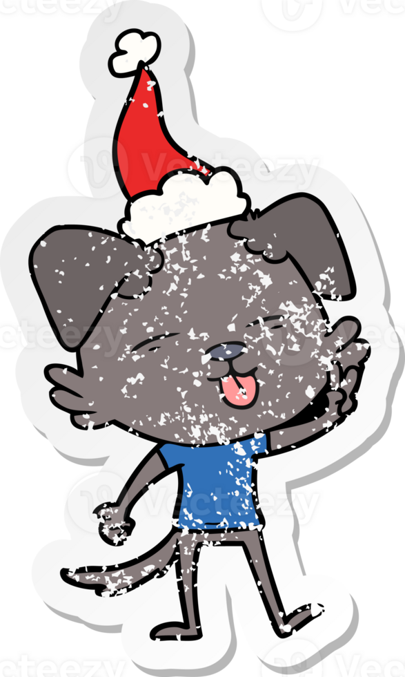 hand drawn distressed sticker cartoon of a dog sticking out tongue wearing santa hat png