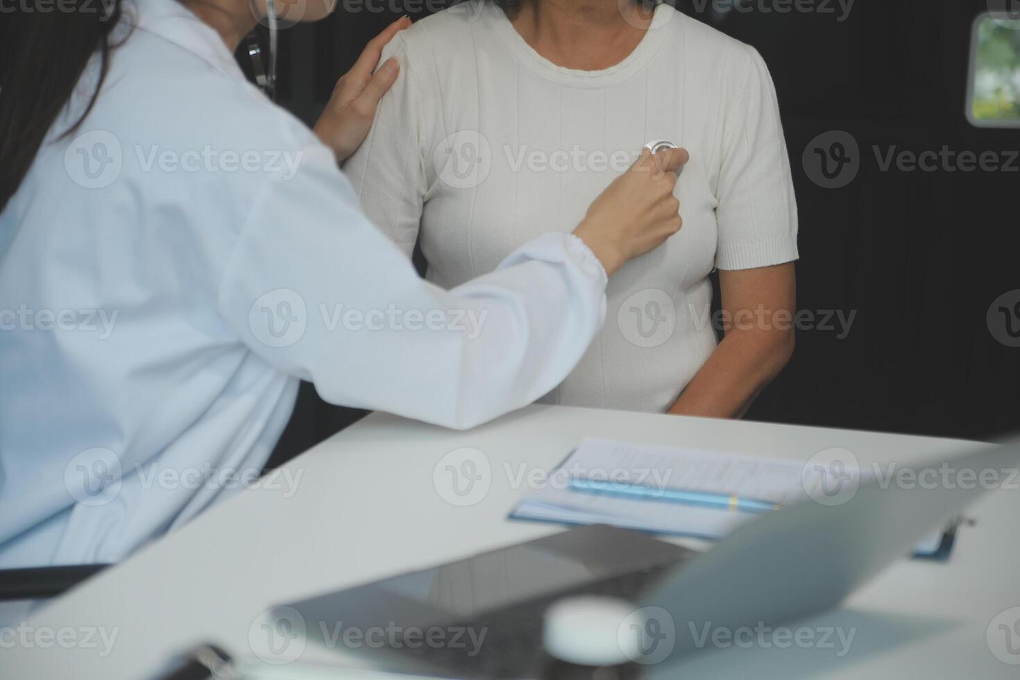 Doctor using sphygmomanometer with stethoscope checking blood pressure to a patient in the hospital. photo