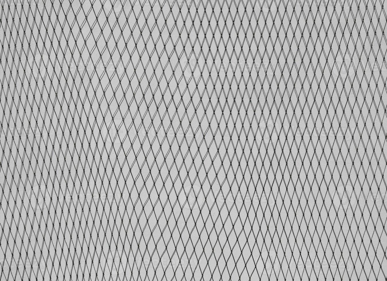 Nylon net on cement wall photo