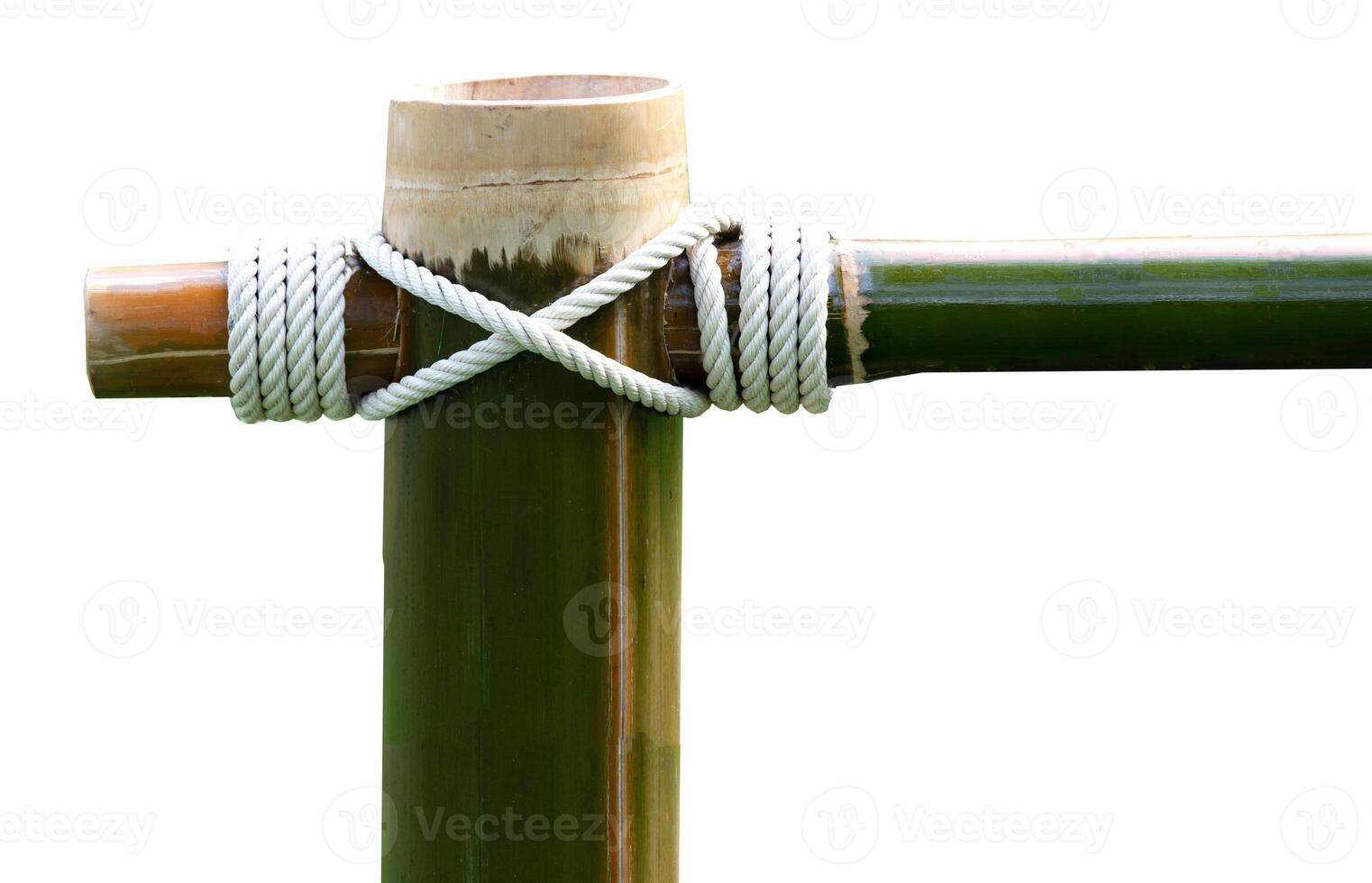 Layers of rope tied around a bamboo log isolated on white background. photo