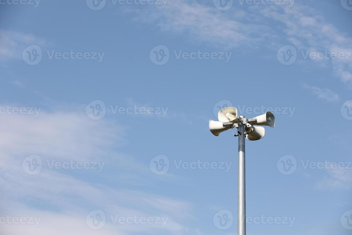 Whire horn speaker with cloud on blue sky background. photo