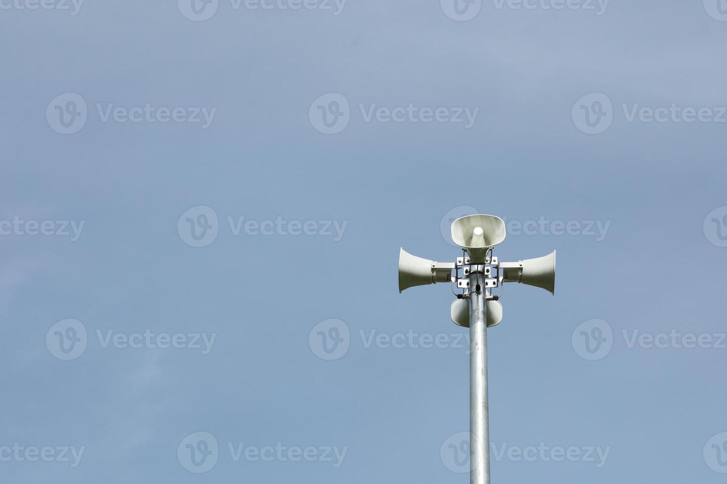 Horn speaker in the park with blue sky background. photo
