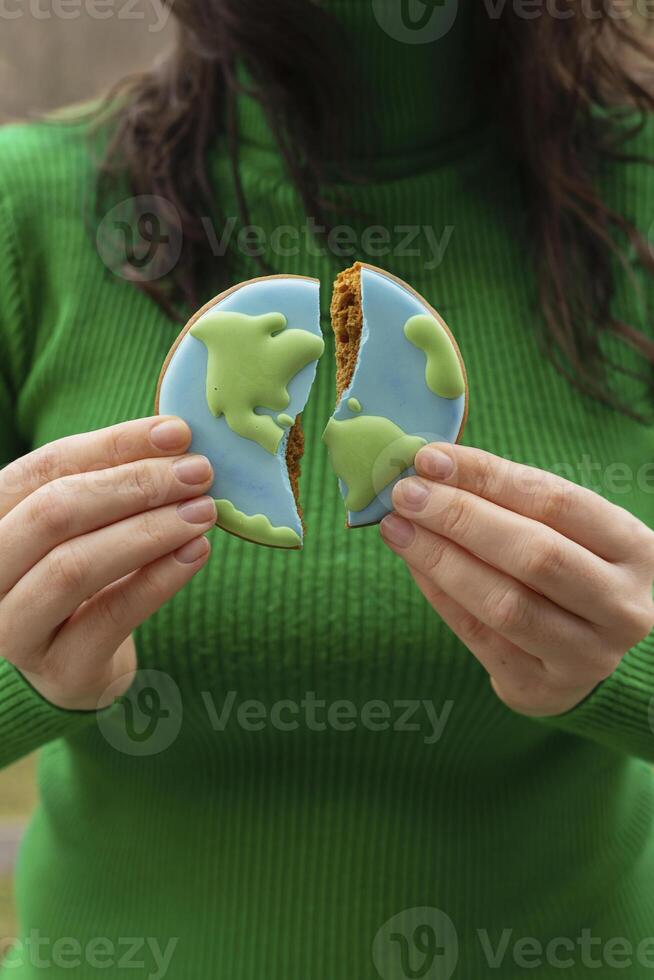 Broken cookies in the shape of the earth. Earth Day concept. Environmental problem. photo