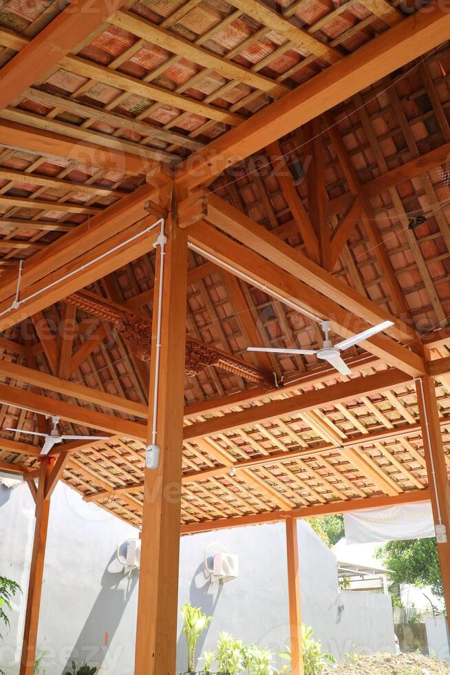 The roof of a simple building, the frame is made of wood. Roof tiles are made from clay photo