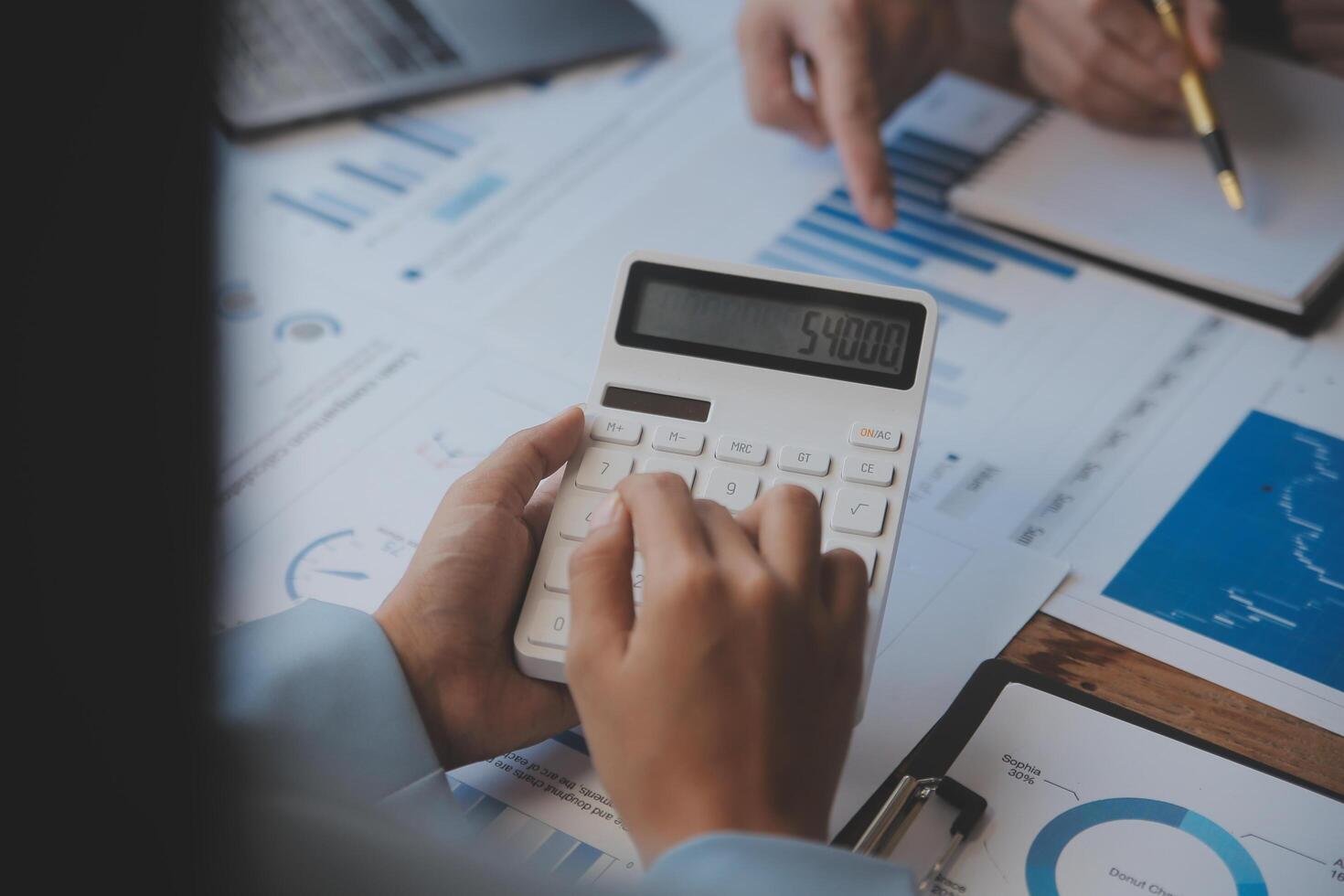 Co working conference, Business team meeting present, investor colleagues discussing new plan financial graph data on office table with laptop and digital tablet, Finance, accounting, investment. photo