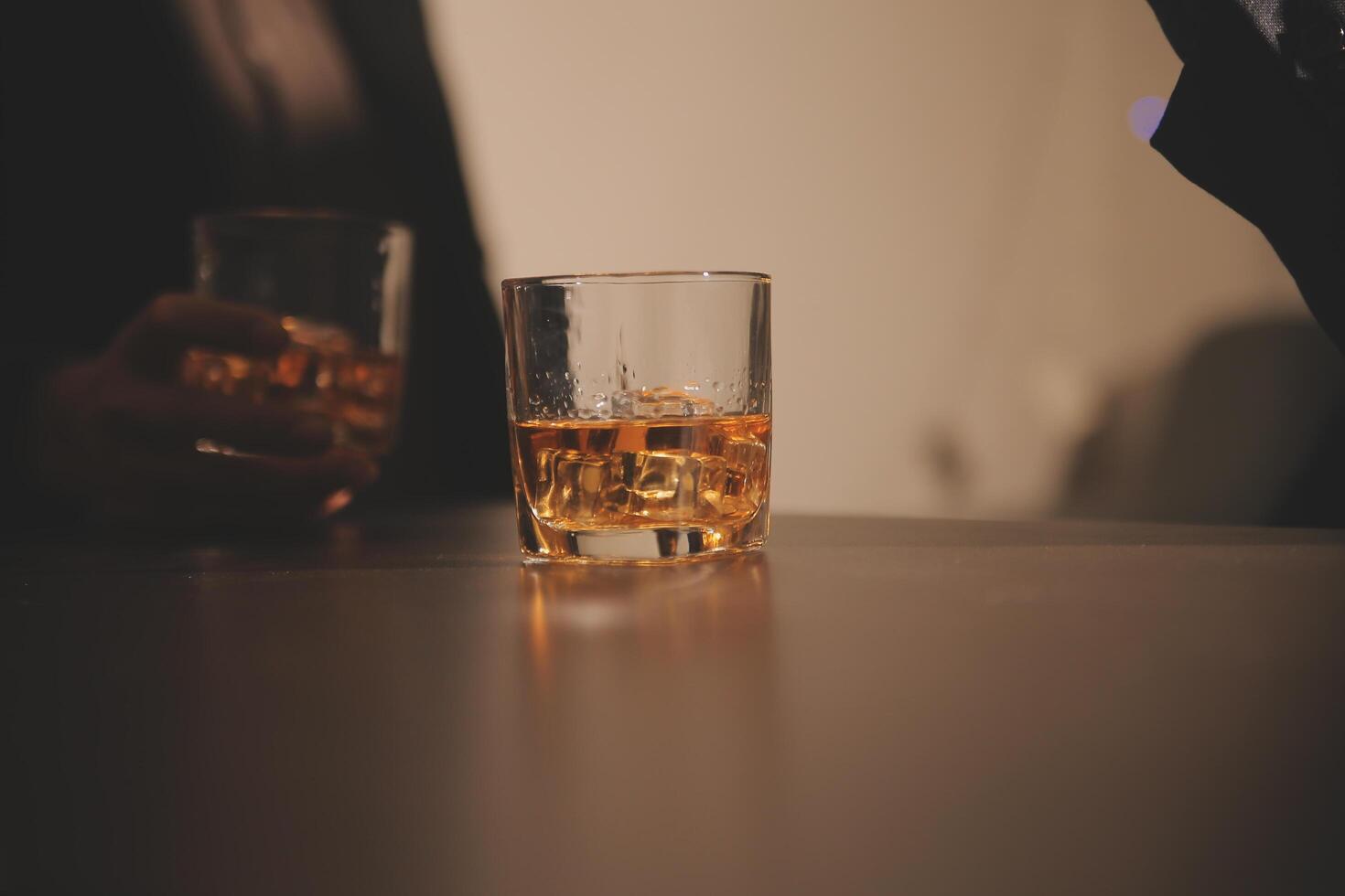 Celebration night, pour whiskey into a glass. Give to friends who come to celebrate photo