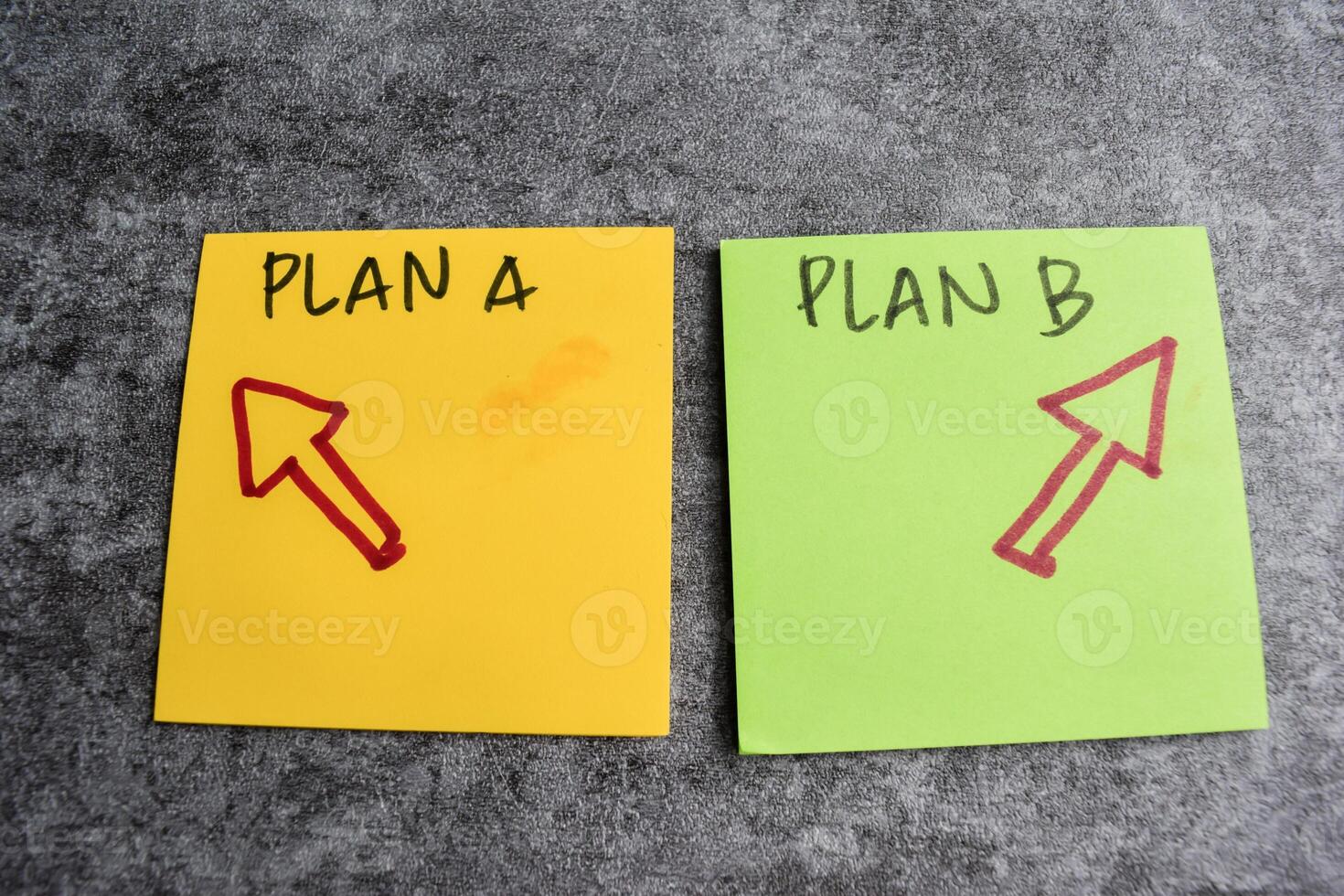 Concept of Plan A or Plan B write on sticky notes isolated on Wooden Table. photo