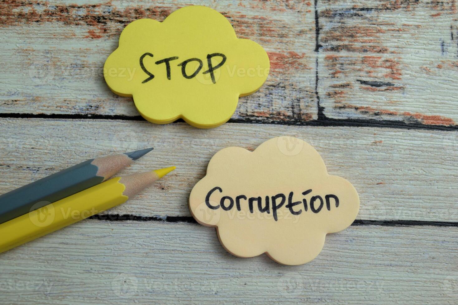 Concept of Stop Corruption write on sticky notes isolated on Wooden Table. photo