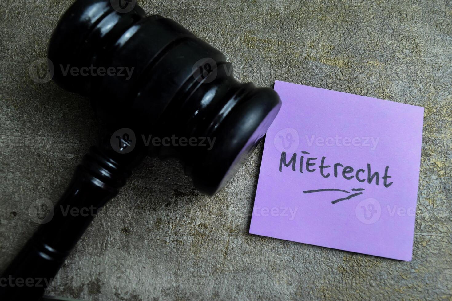 Concept of Learning language - German. Mietrecht it means Tenancy law written on sticky notes. German language isolated on Wooden Table. photo