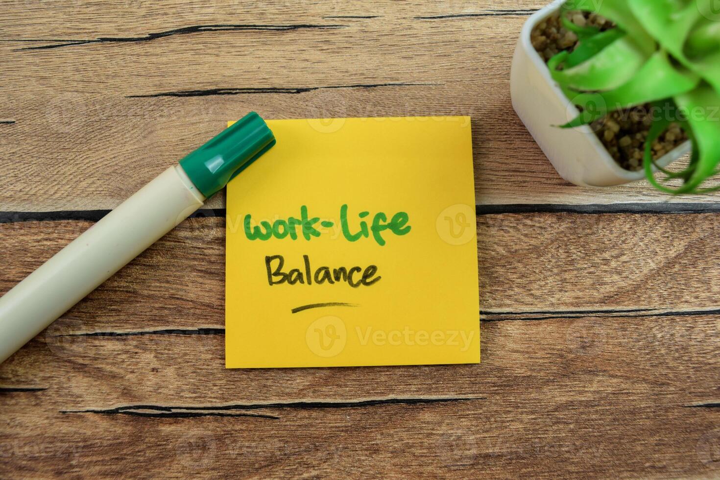 Concept of Work-Life Balance write on sticky notes isolated on Wooden Table. photo