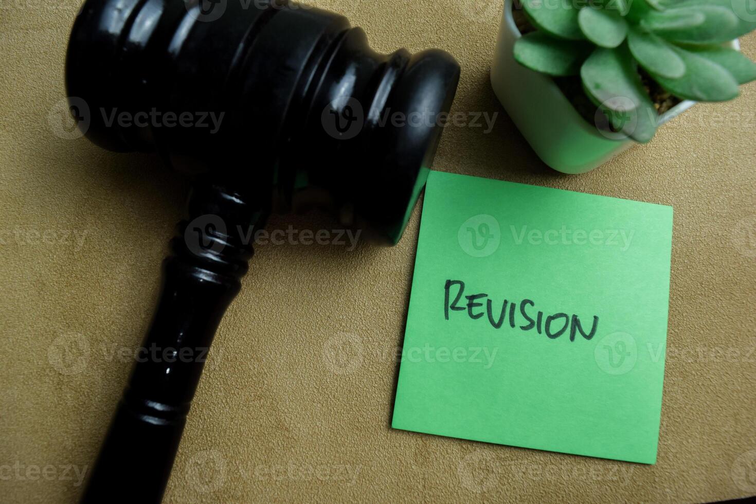 Concept of Revision write on sticky notes isolated on Wooden Table. photo