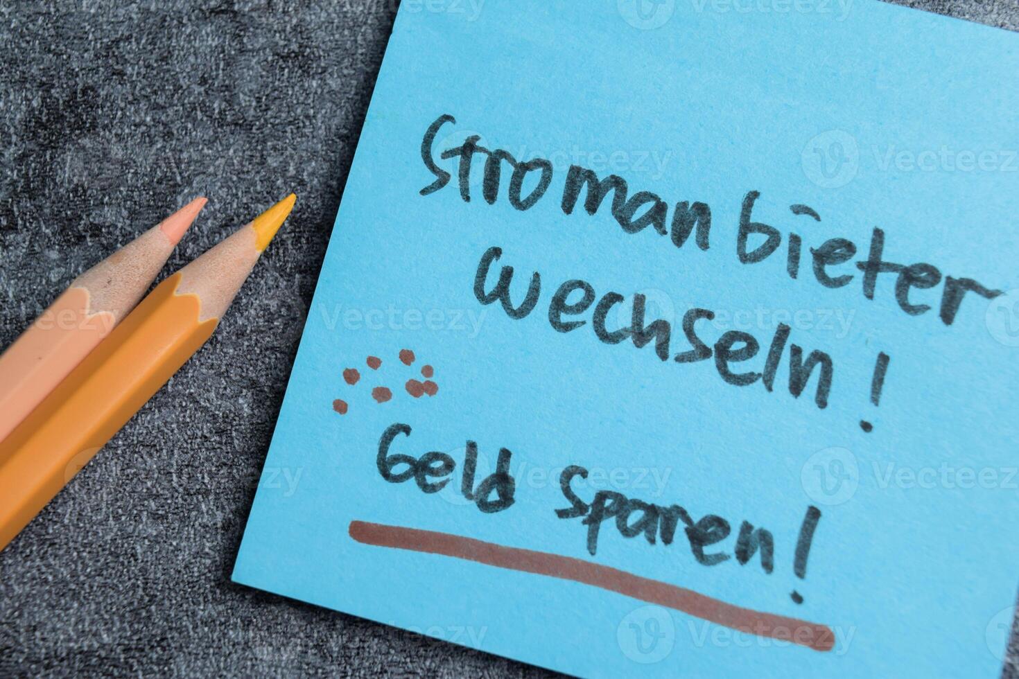 Concept of Stromanbieter Wechseln - Geld Sparen write on sticky notes isolated on Wooden Table. photo