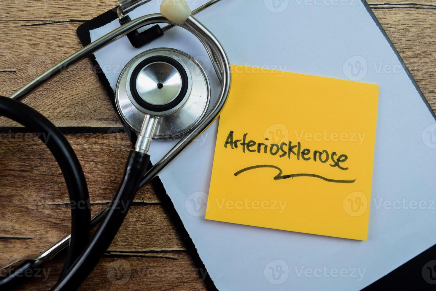 Concept of Arteriosklerose in Language Germany write on sticky notes isolated on Wooden Table. photo