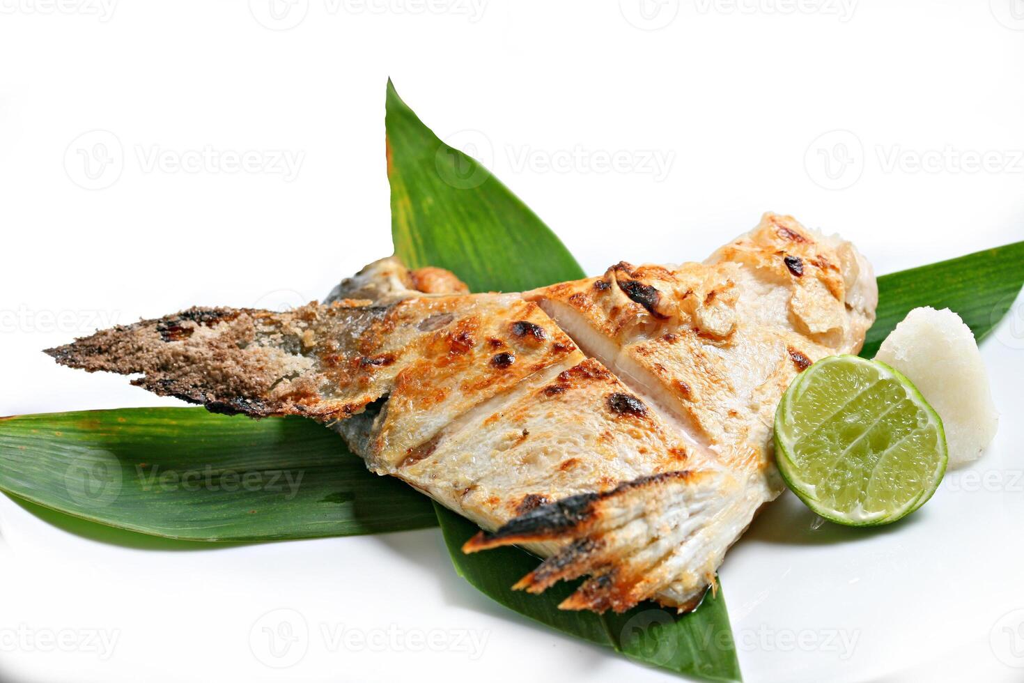 Charcoal Grilled Hamachi kama, Japanese Food Style served with lemon in white background photo