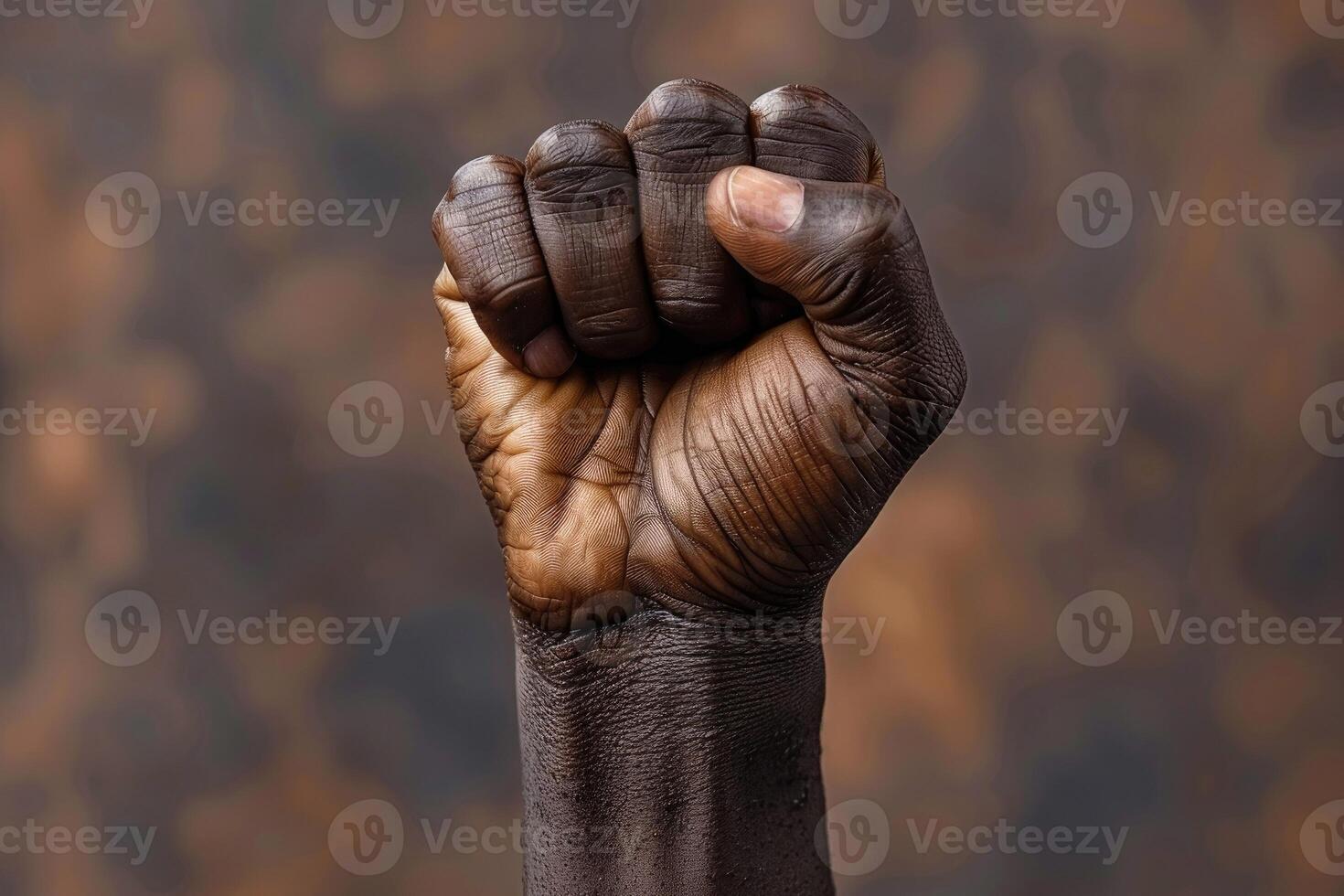 The hand of an African American with a fist raised to the top symbolizing freedom and equal rights. Emancipation and Freedom Day celebrating June 19 photo