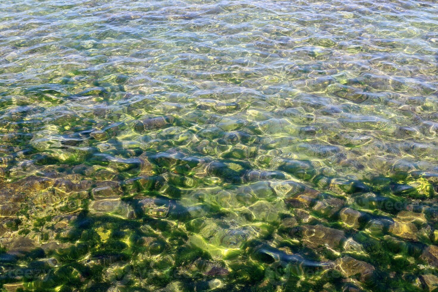 The color of water in the Mediterranean Sea in shallow water. Natural abstract background. photo
