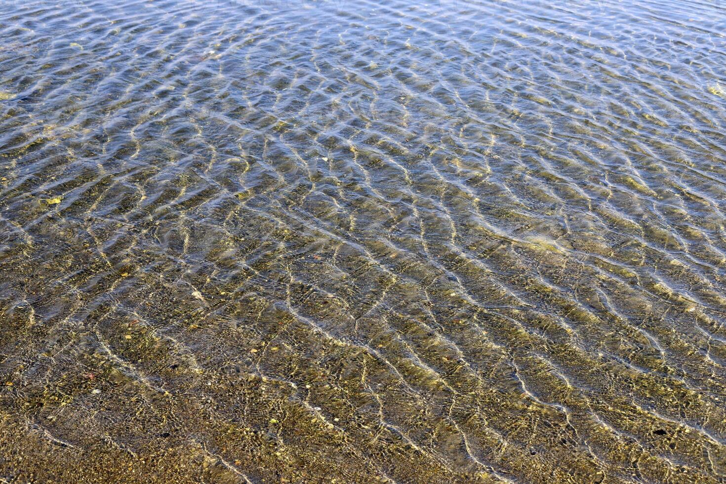 The color of water in the Mediterranean Sea in shallow water. Natural abstract background. photo