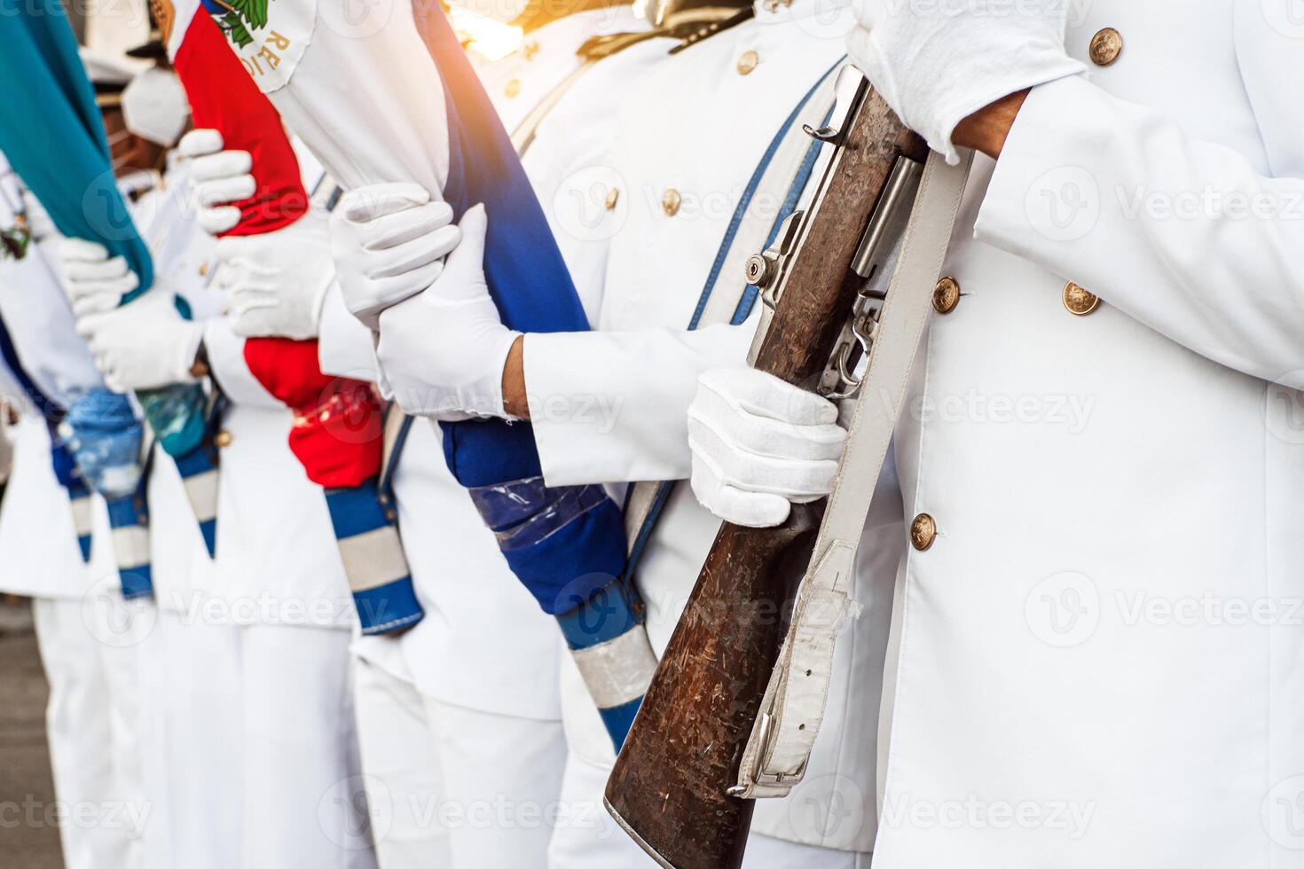 Marines with gloves in the hands holding a rifle and flags. photo