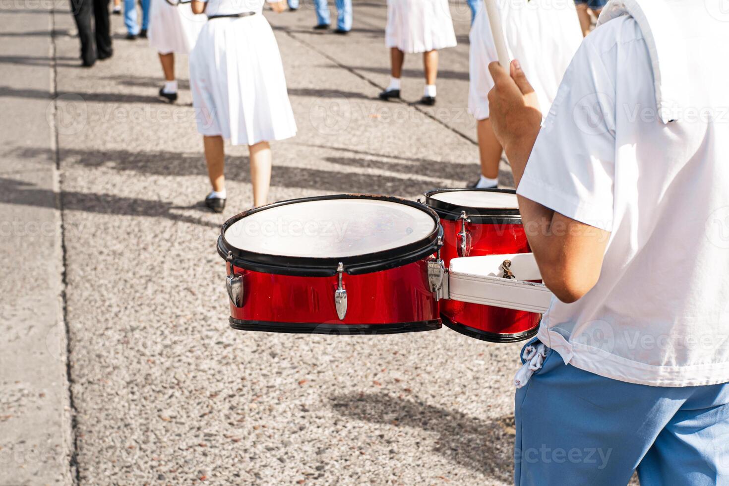 Hands of a percussionist playing an instrument in a parade. photo