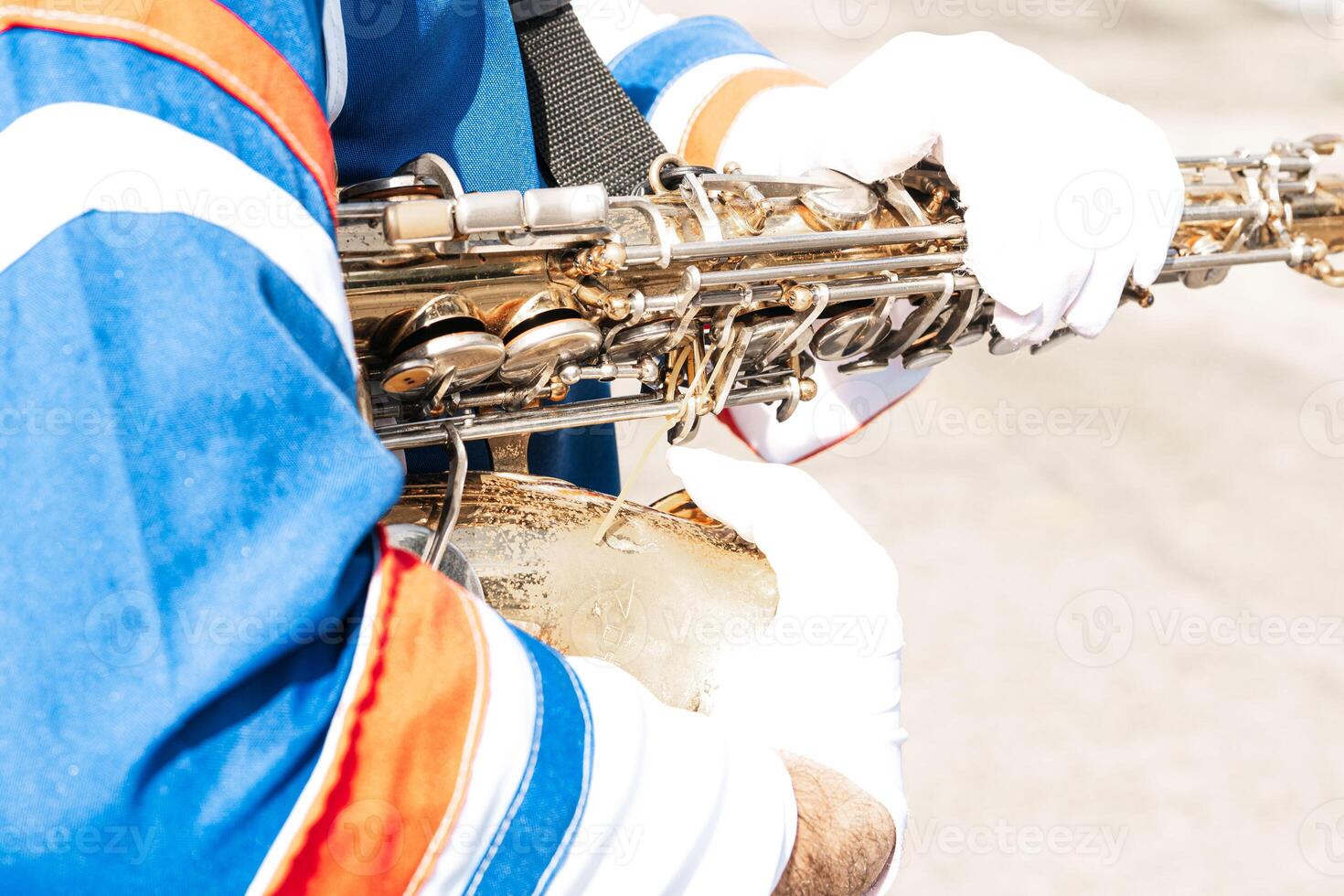 Closeup of marching band holding a saxophone. photo