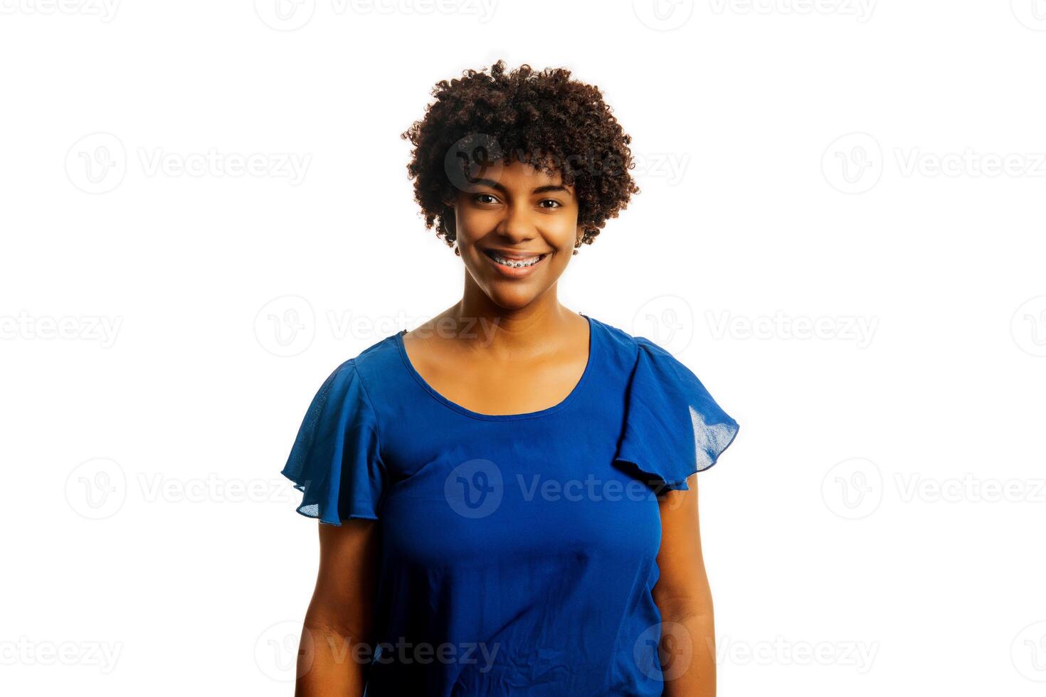 Portrait of black woman wearing braces smiling looking at camera over white background. photo