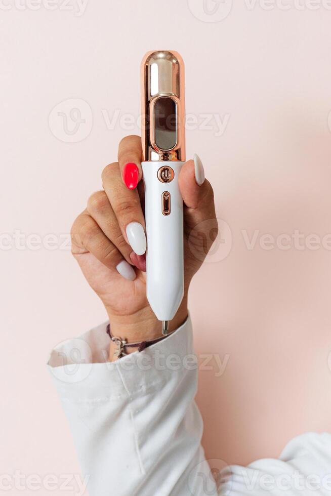 Hands Holding On Fibrolast Machine. photo