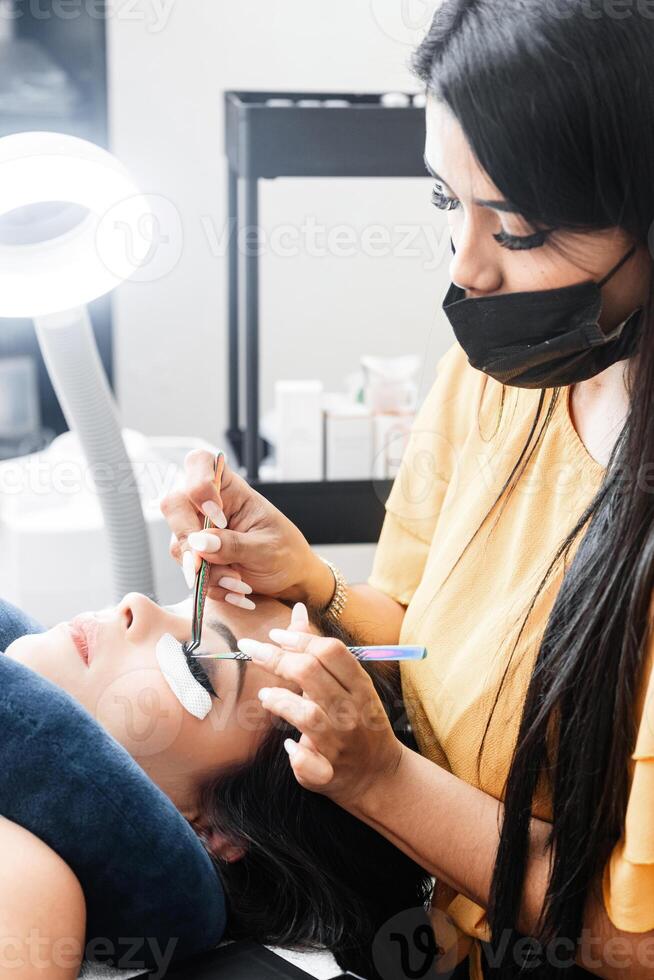Woman Getting Eyelash Lifting Procedure in Salon. Small Business Concept. photo