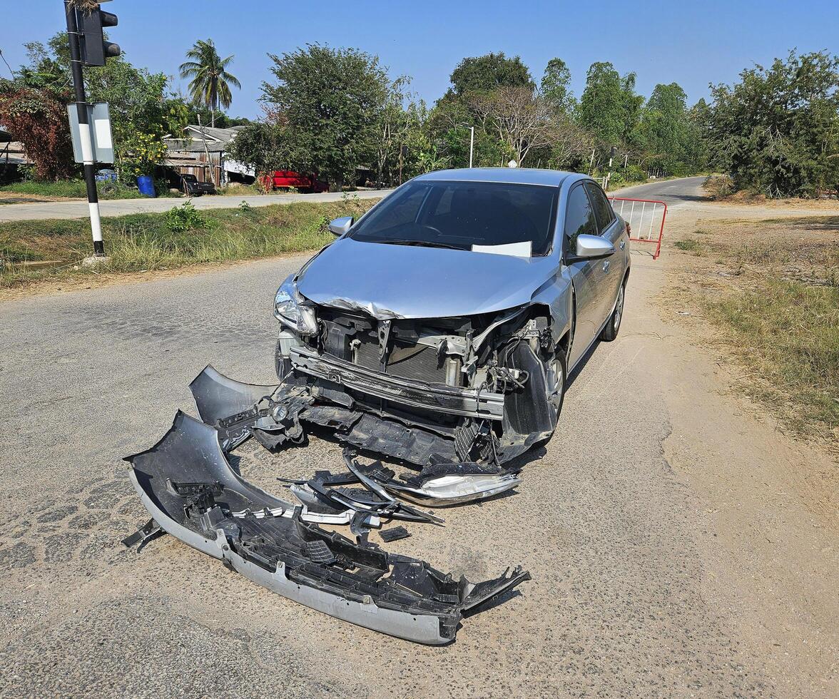 Bronze, gray or grey car broke or accident and crash with 6 wheel truck with trailer on street or road. Damaged or injured on front bumper and car radiator. Broken and insurance of vehicle concept. photo
