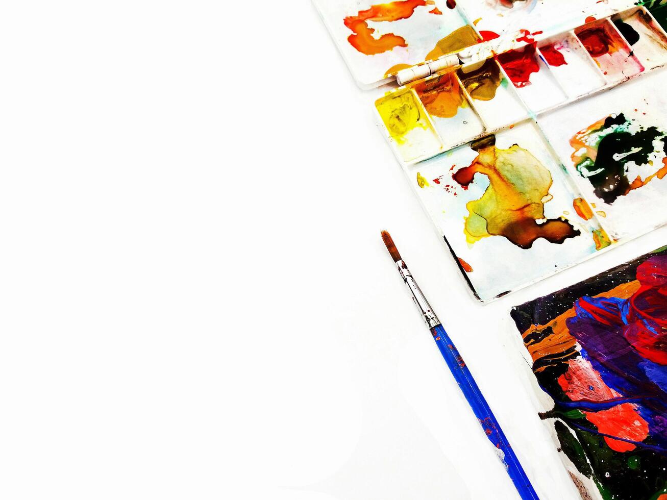 Blue paintbrush and white palette be stained water color isolated on white background. Artist tool and colorful background concept photo