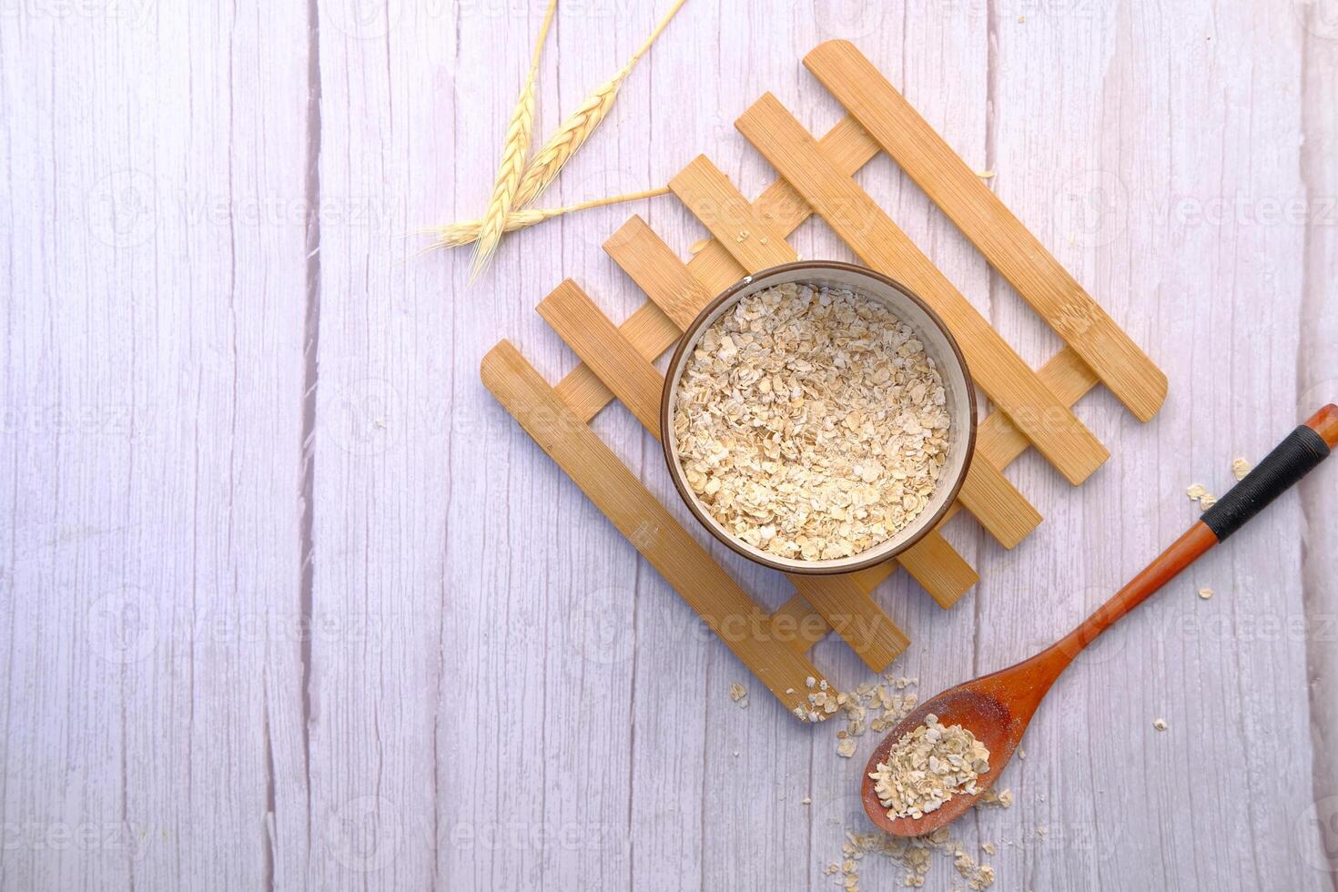 top view of oats flakes in a bowl on table photo