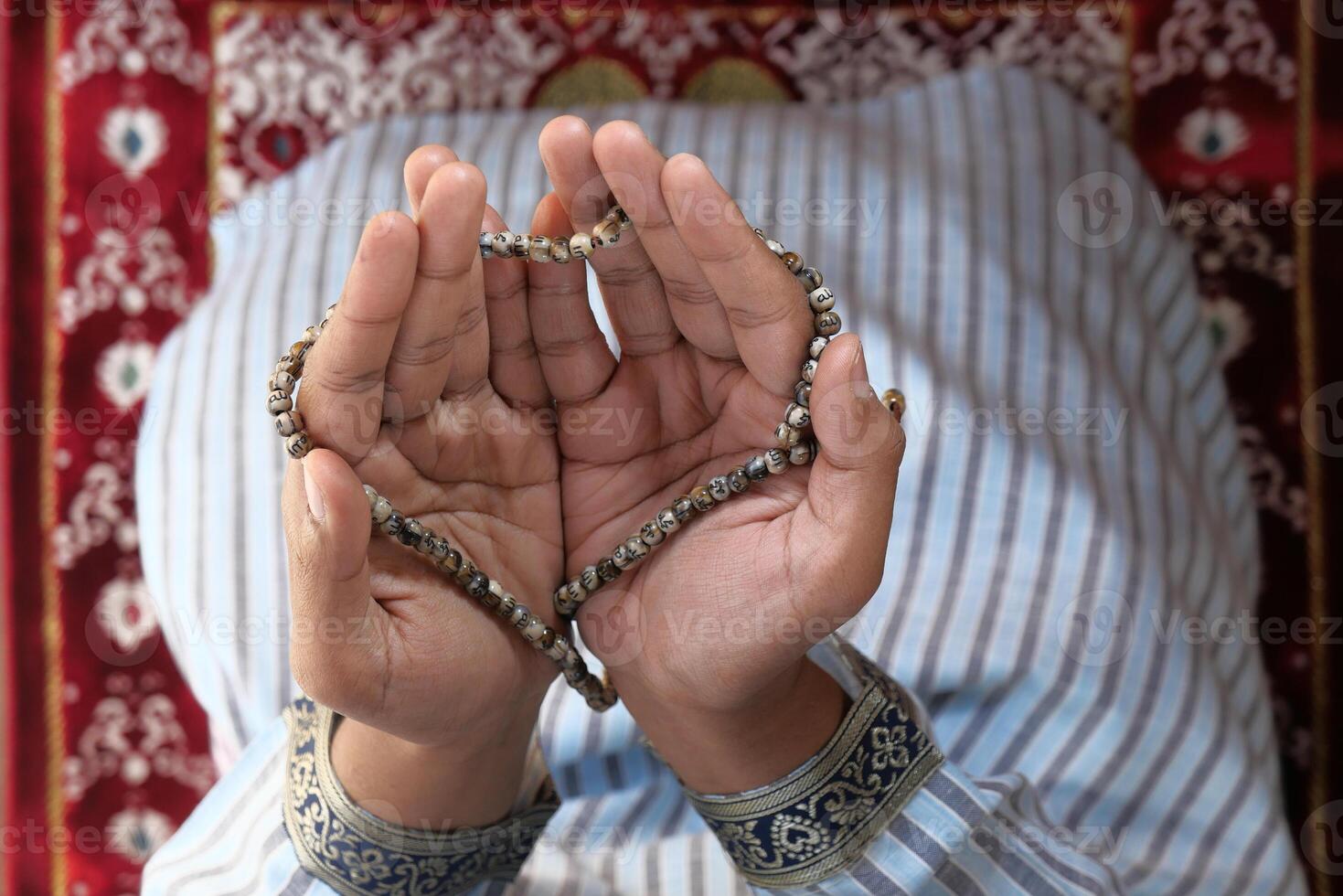 high angle view of muslim man hand praying for ramadan photo