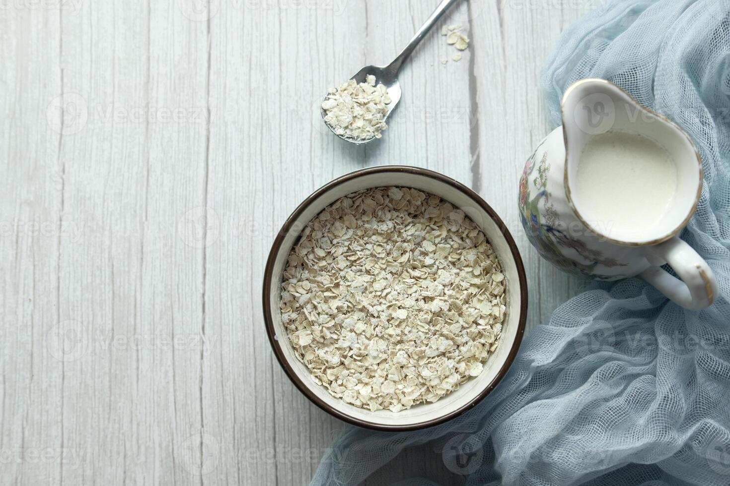 high angle view of oats flakes in a bowl on table photo