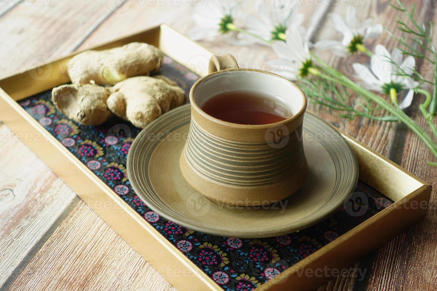 Ginger tea on wooden background. photo