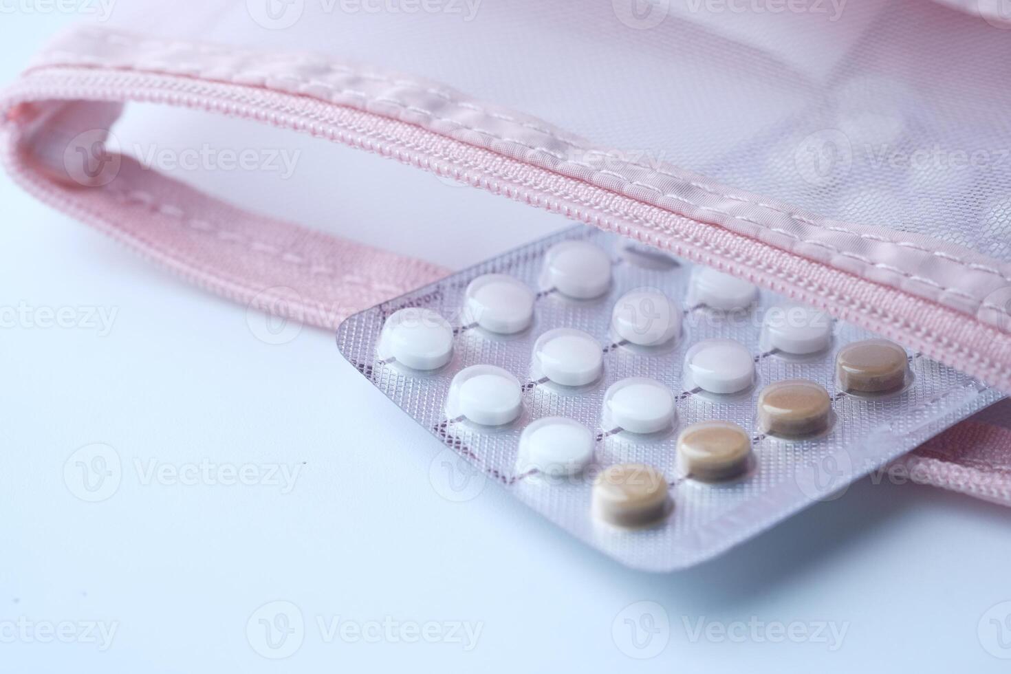birth control pills on white background, close up photo