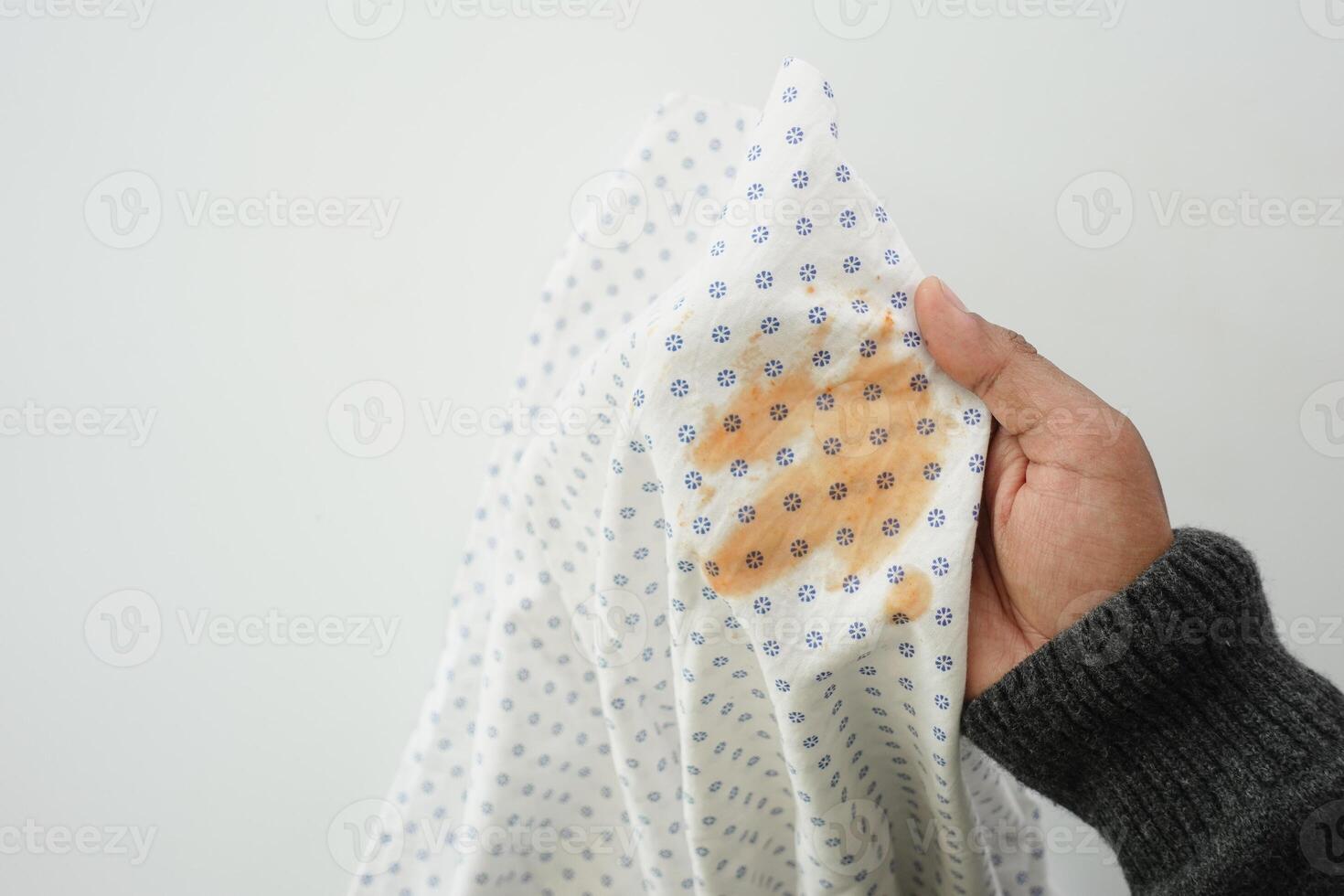 Tomato sauce spilled on white fabric photo