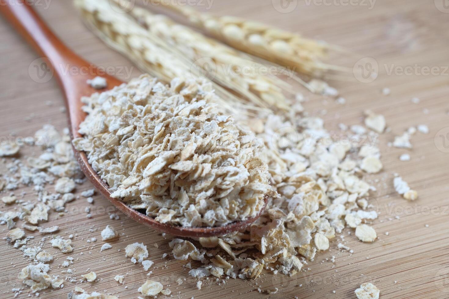 Close up of oats flakes on spoon on table photo