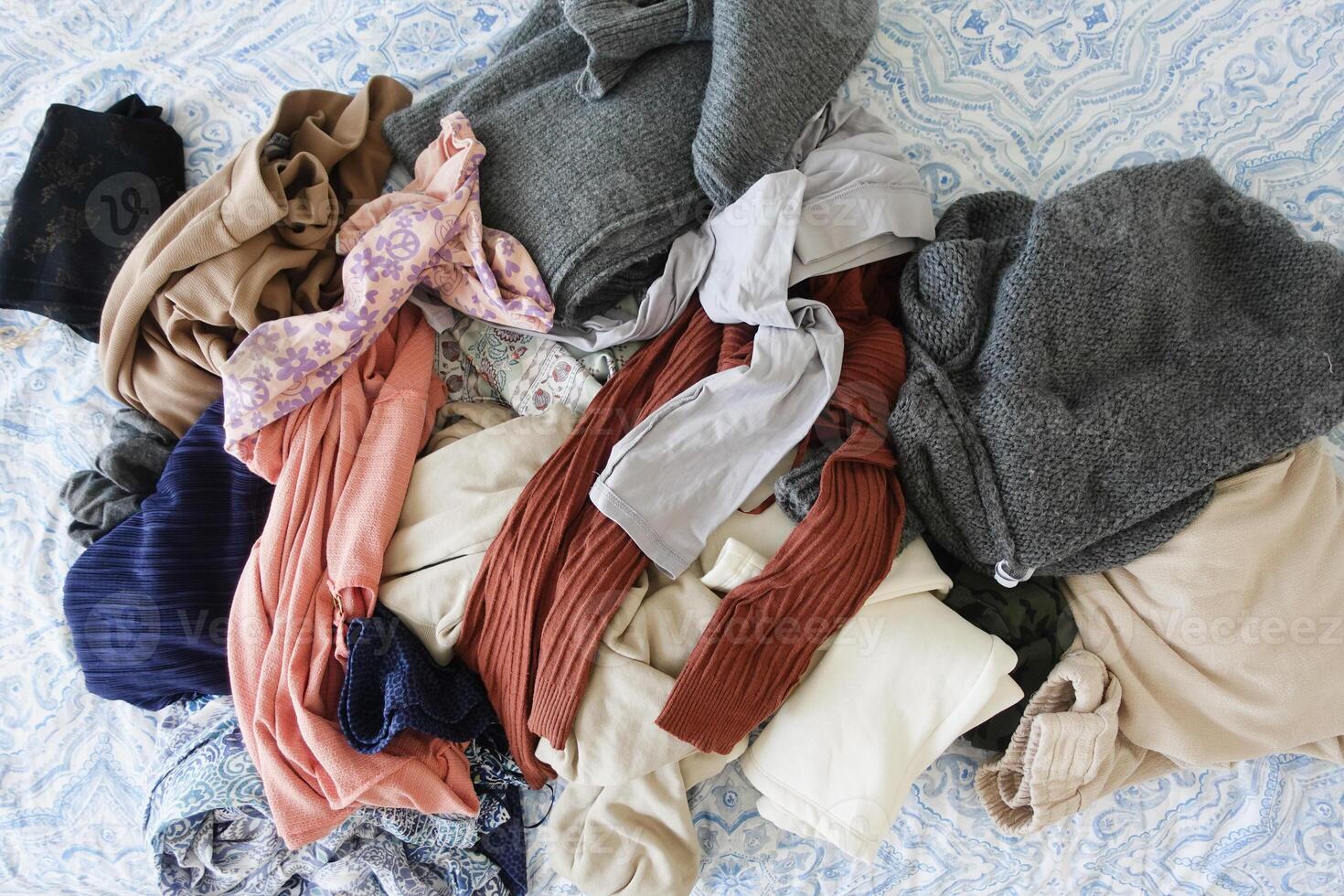 messy bed with cloths in early morning , messy bed after waking up photo