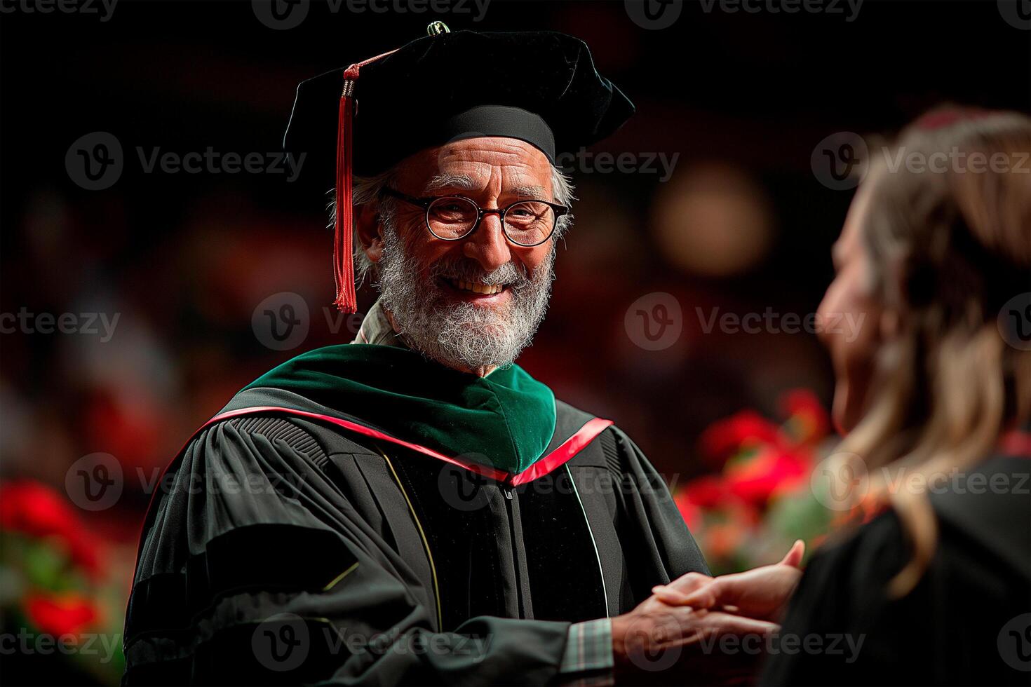 University president or dean congratulating graduates as they walk across the stage, education and graduation concept photo