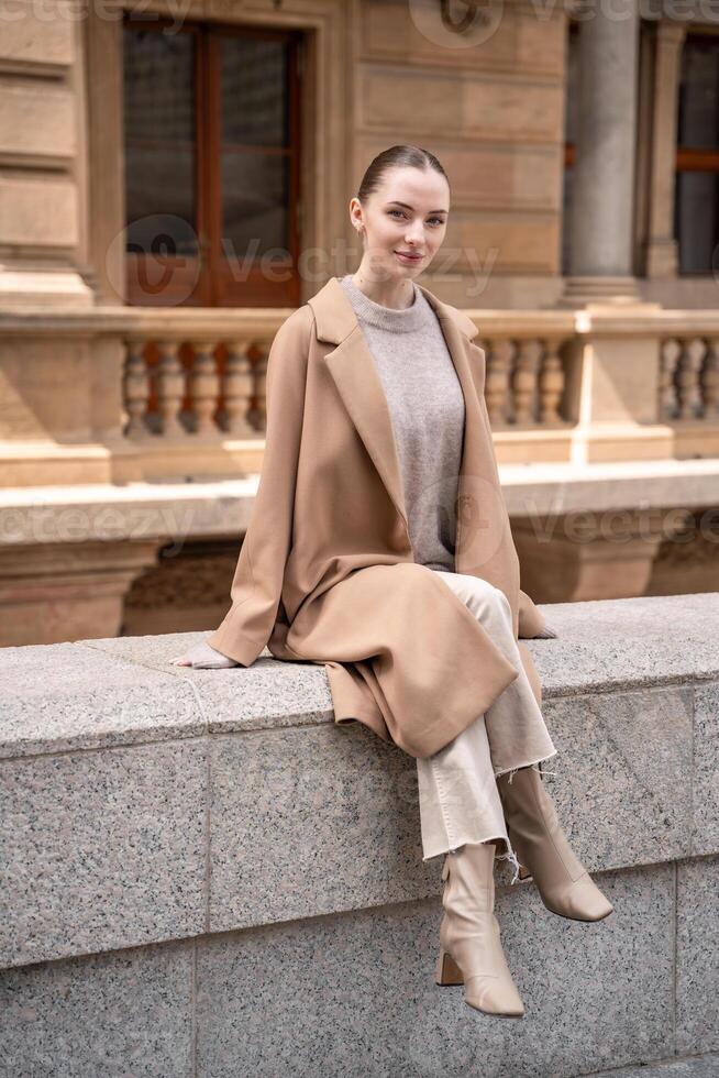 Young beautiful woman wearing coat walking in the city centre of Prague, Czech republic, Europe photo