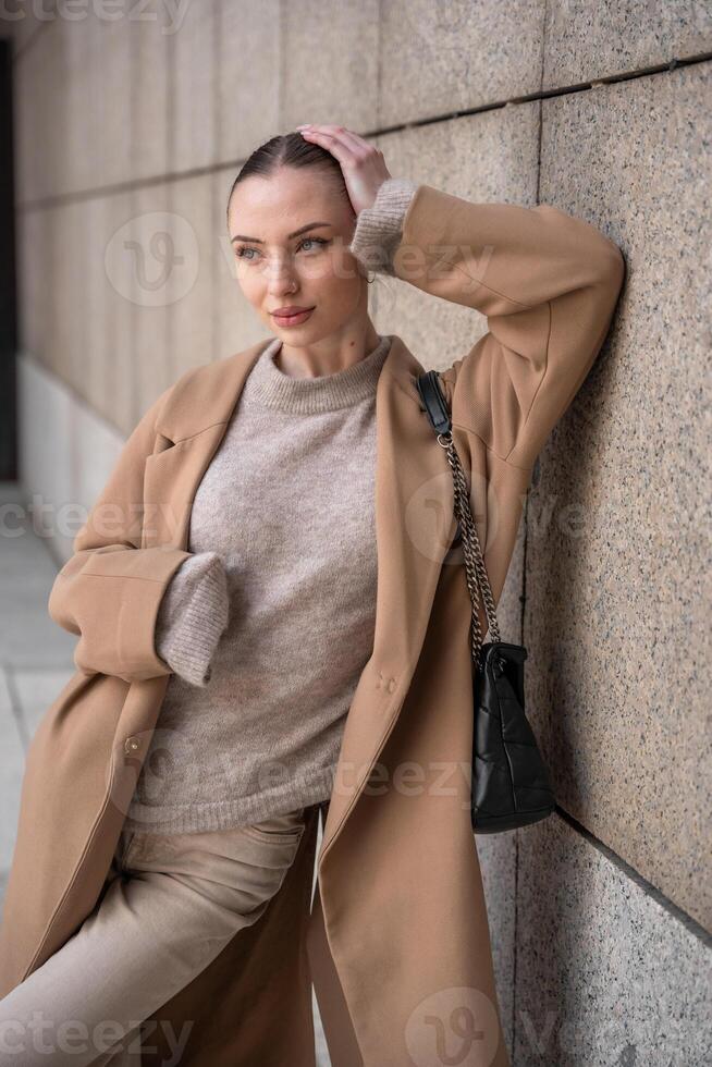 Young beautiful woman wearing coat walking in the city centre of Prague, Czech republic, Europe photo