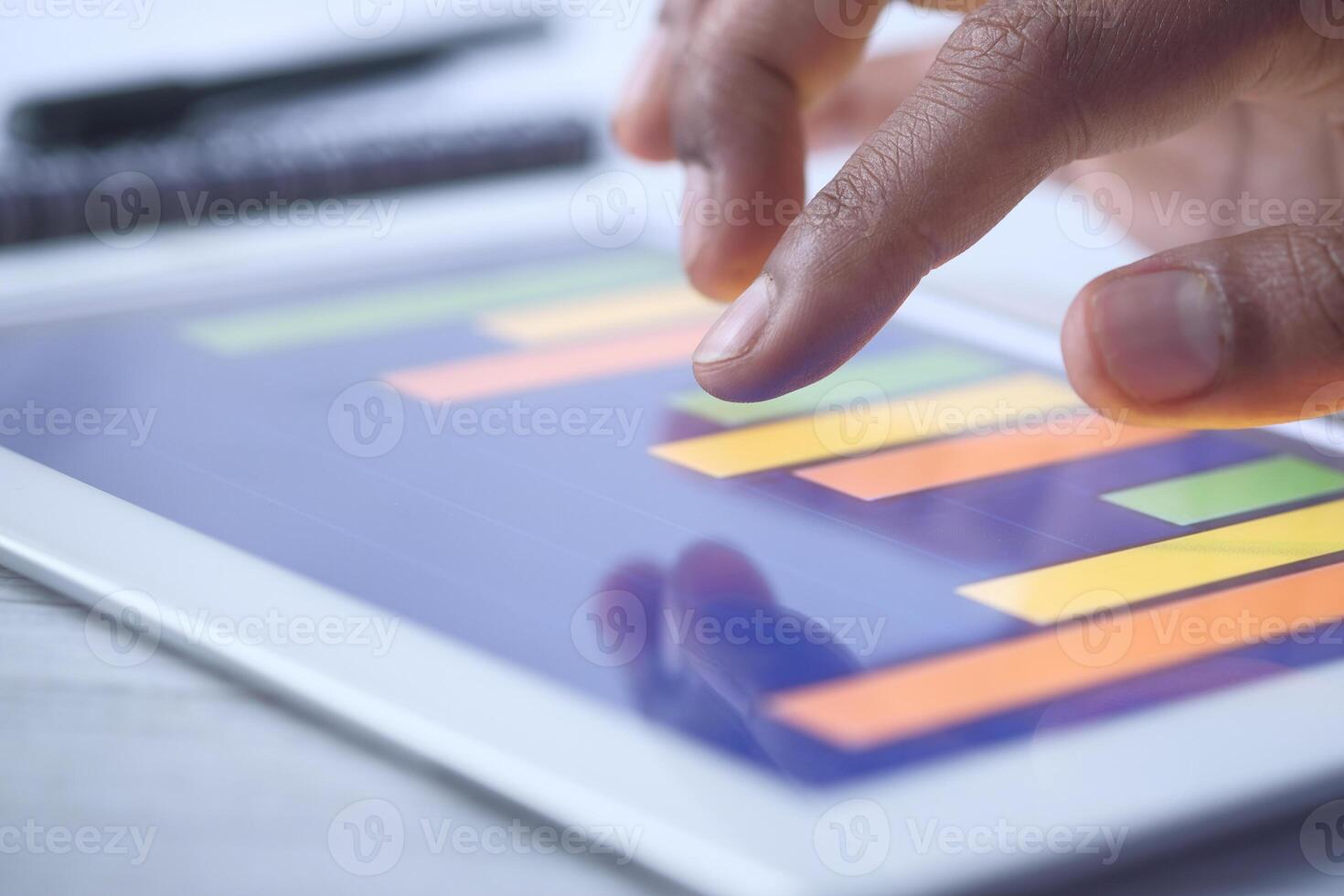 person hand analyzing financial data on digital tablet photo